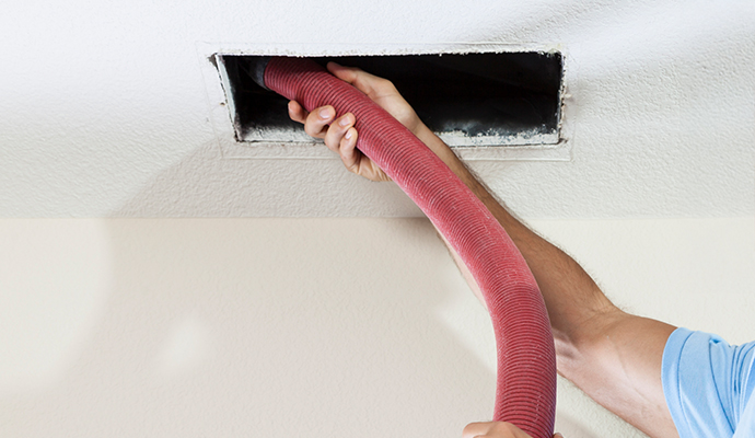 professional worker cleaning air-duct