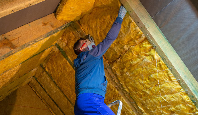 Professional person installing new insulation after fire damage