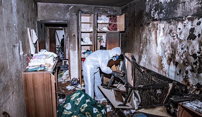 professional worker restoring a fire damaged room