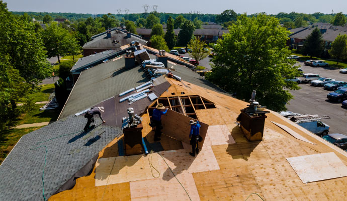 Person repairing the damaged roof